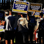 People raising signs against Stewart Gibson